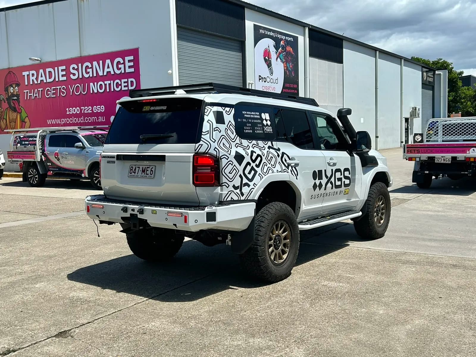TJM XGS Prado rear three-quarter, ProCloud signage behind