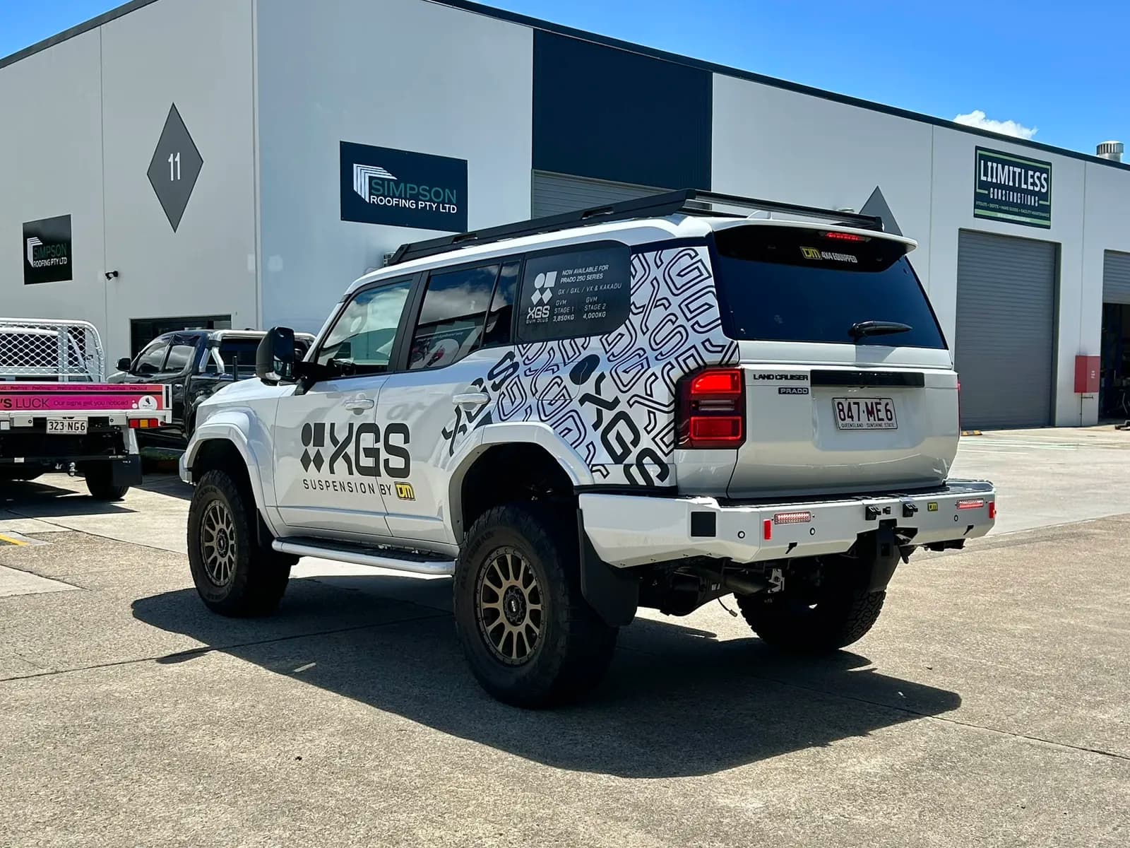TJM XGS Prado rear three-quarter, Simpson Roofing behind