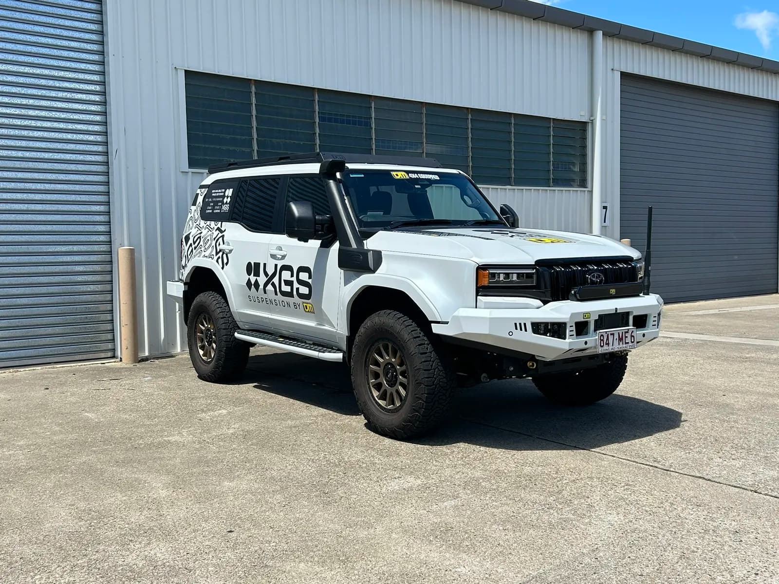 TJM XGS Prado front three-quarter by roller door