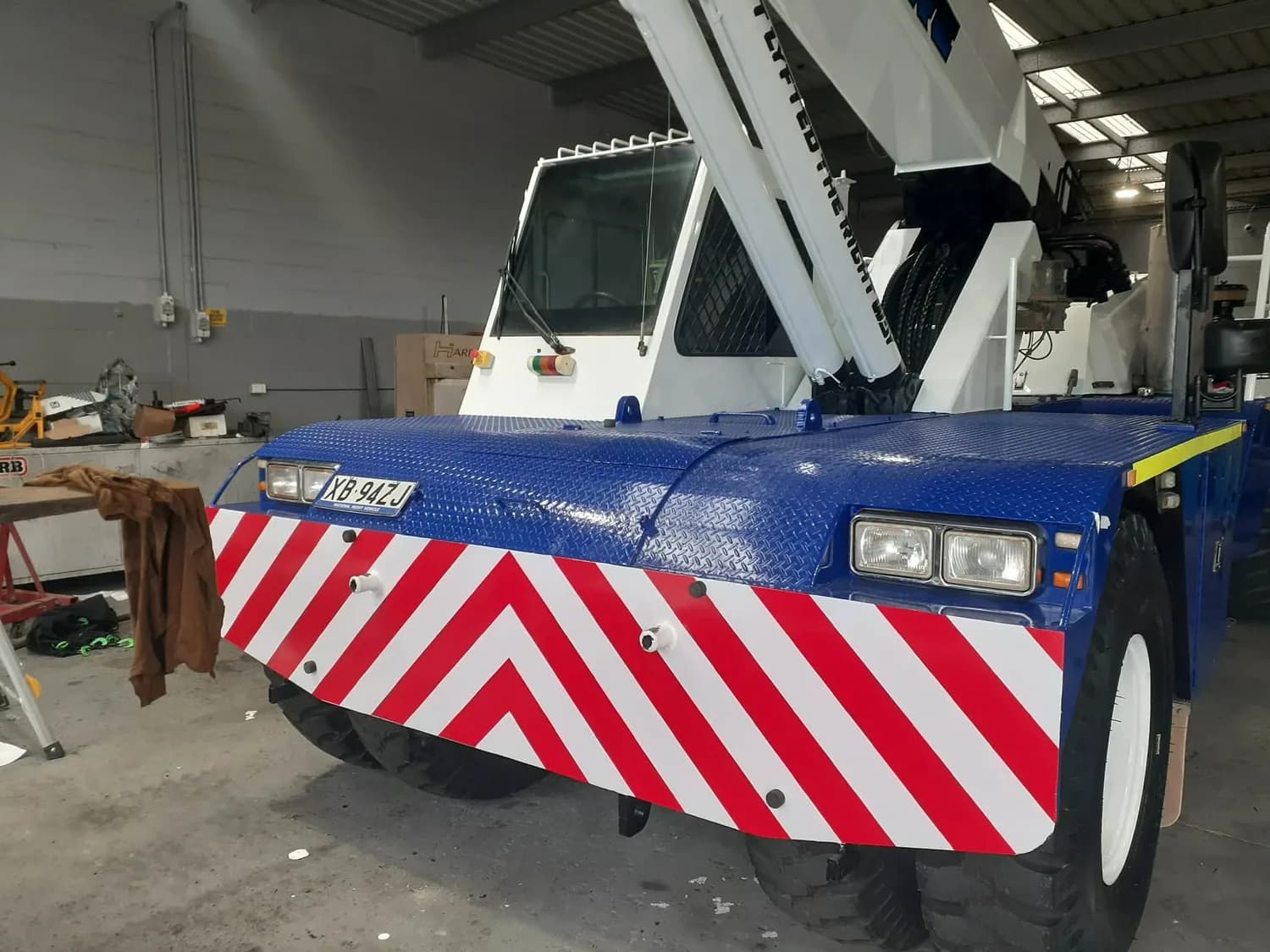 Mobile crane cab wrap with red/white chevron hazard markings