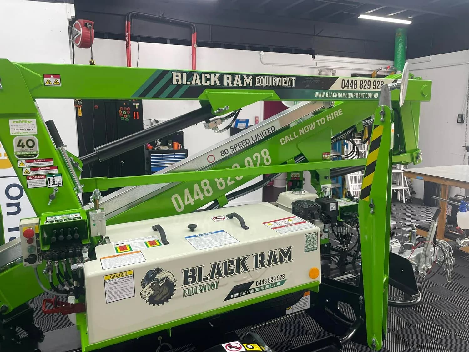 Green Black Ram Equipment boom lift indoors