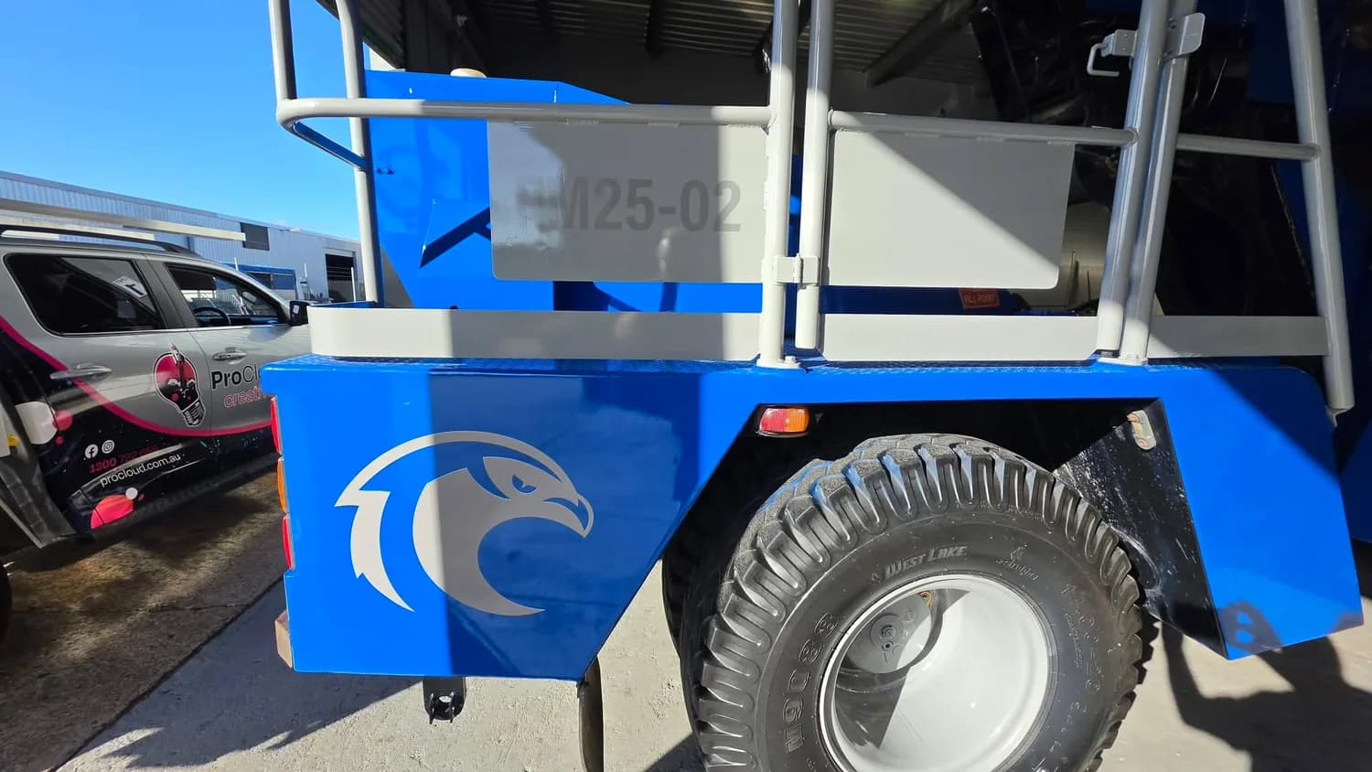 Blue mobile crane wheel and eagle logo detail
