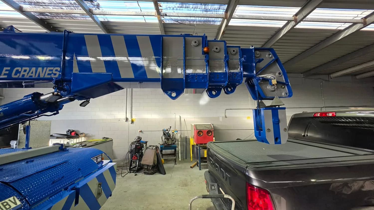 Blue mobile crane boom detail in workshop