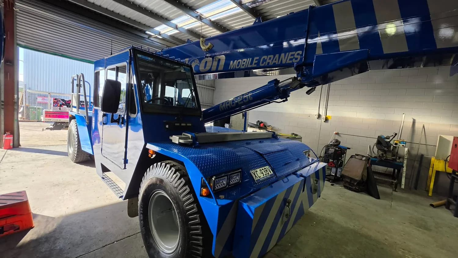 Blue mobile crane wrap, front three-quarter view