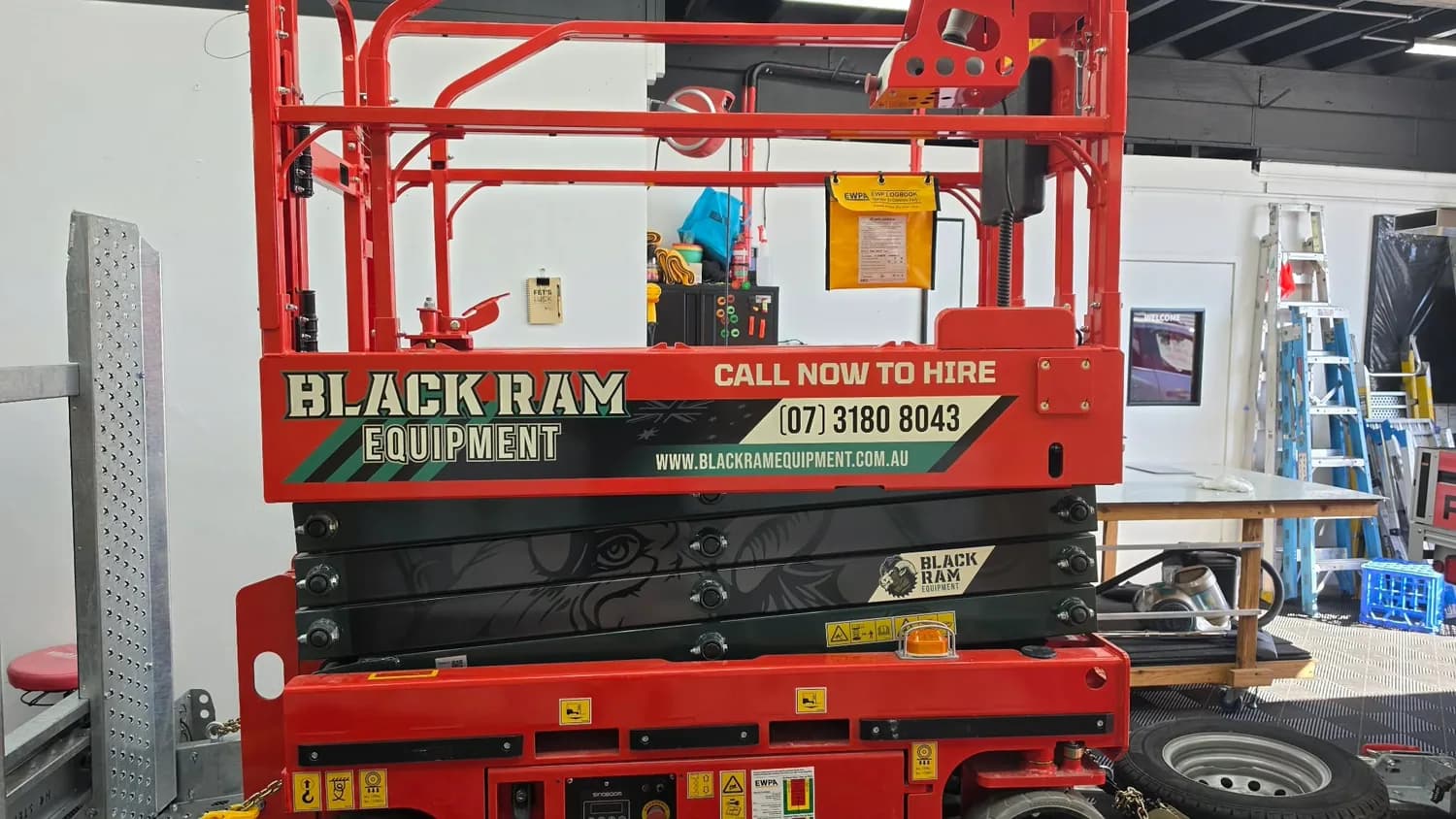 Black Ram Equipment red scissor lift, workshop
