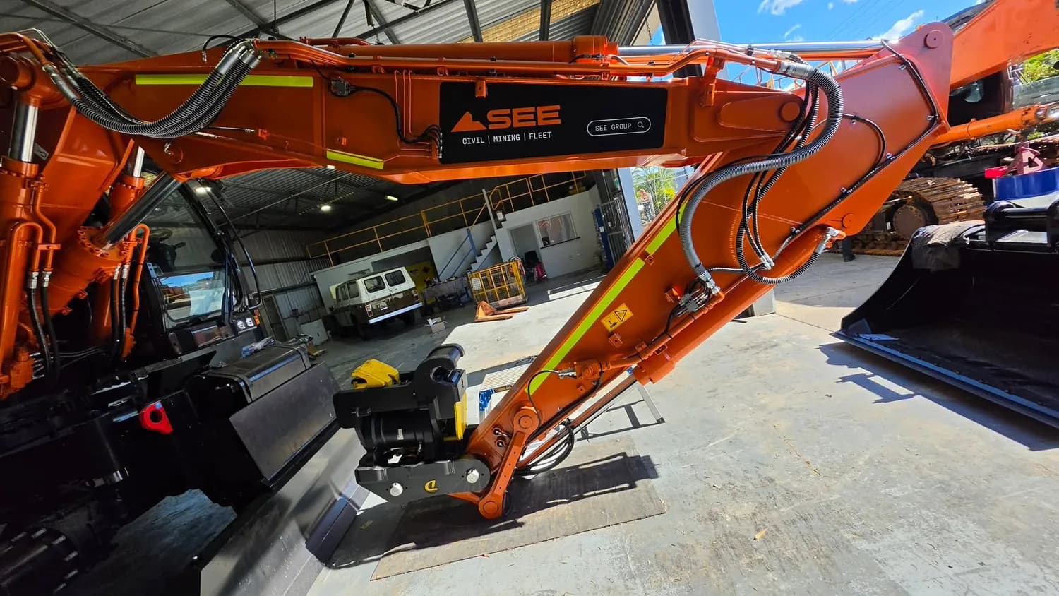 SEE orange excavator arm detail in workshop