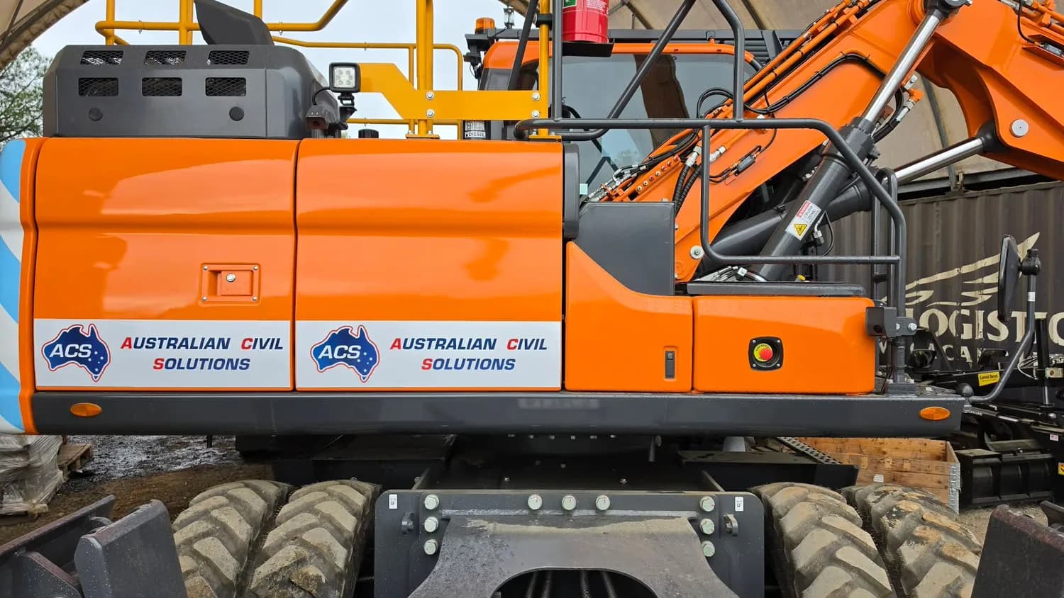 Australian Civil Solutions orange excavator body branding