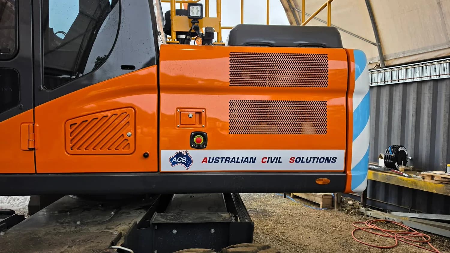 Australian Civil Solutions orange excavator cab and door decals