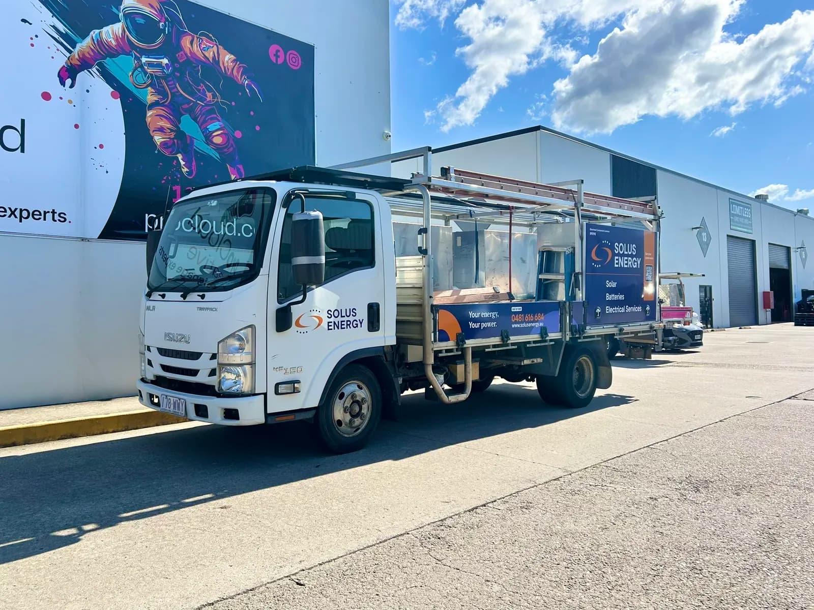 Solus Energy truck front three-quarter, ProCloud mural behind