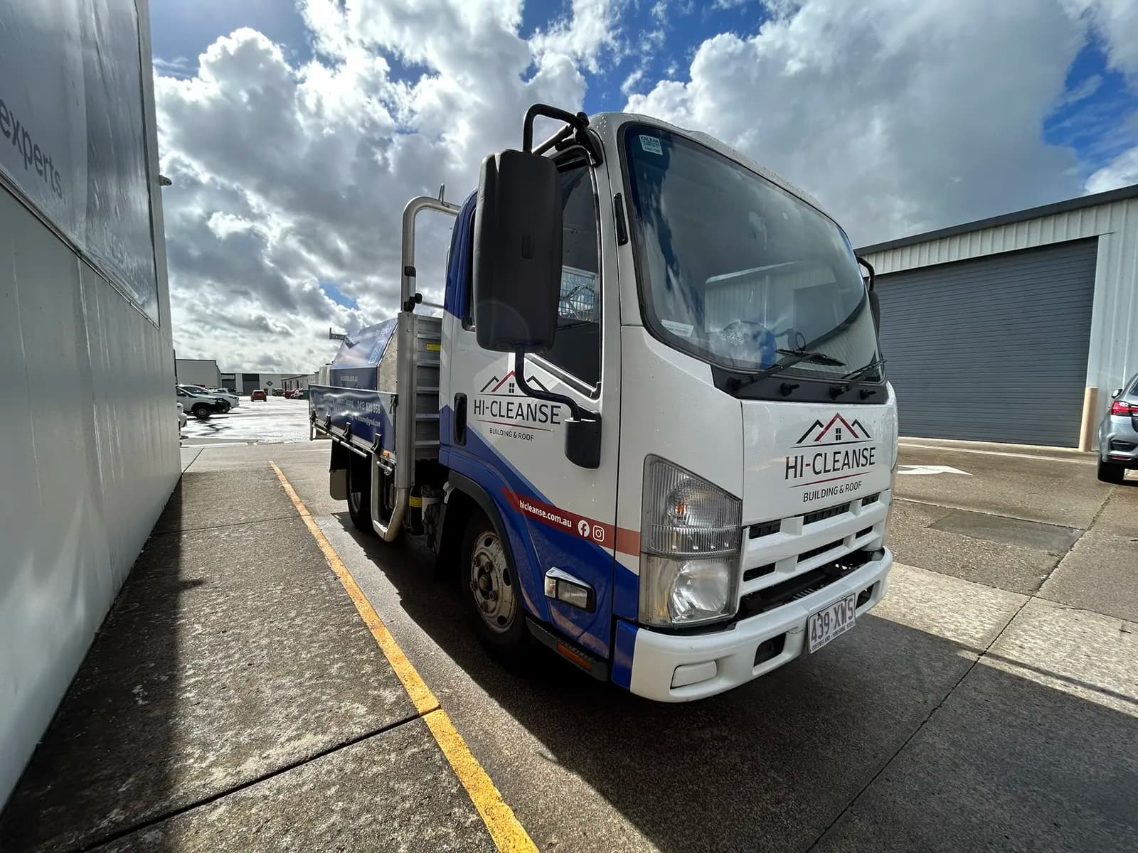 Hi-Cleanse Isuzu truck front, dramatic clouds