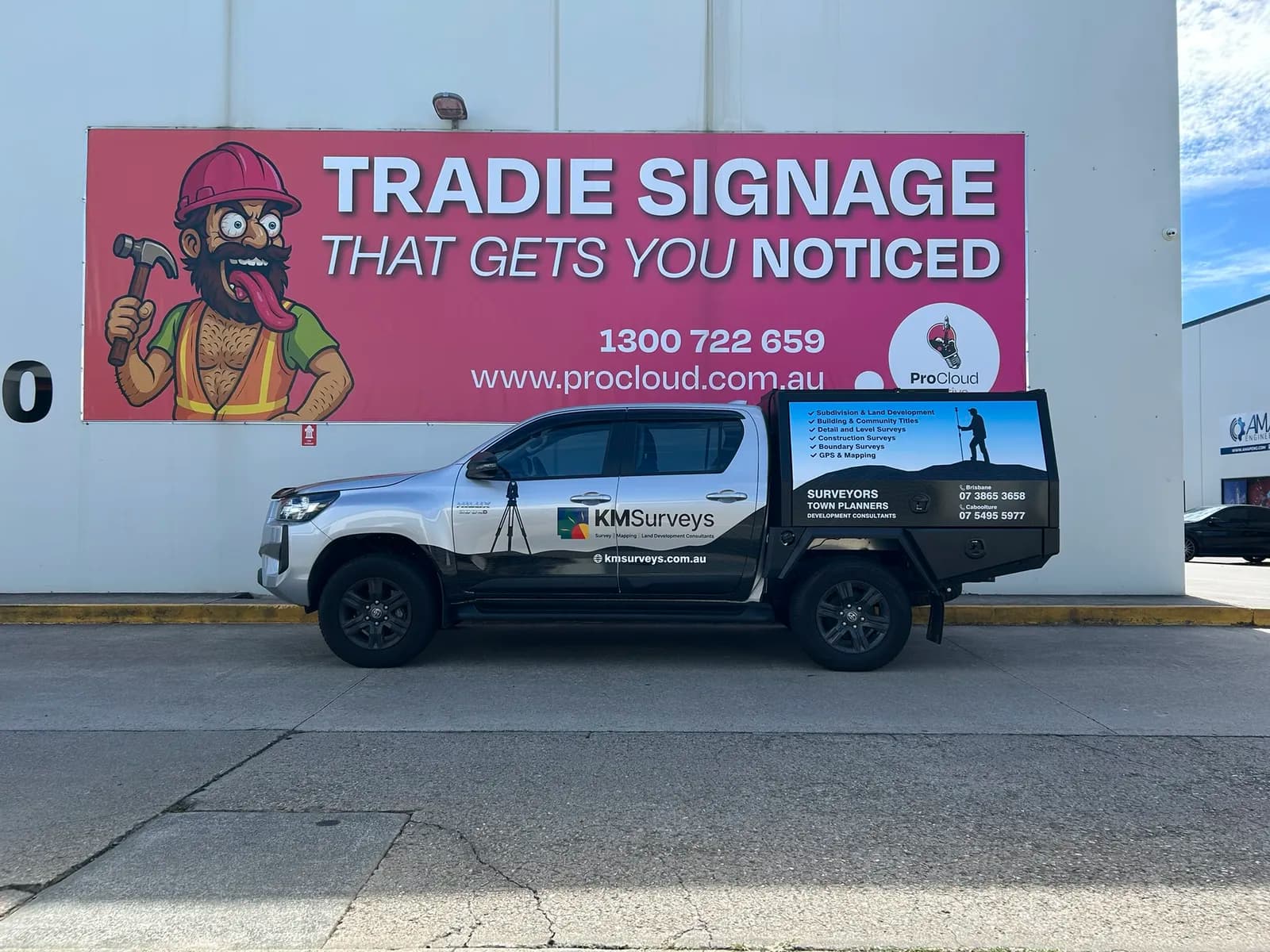 KM Surveys Hilux full side profile with banner