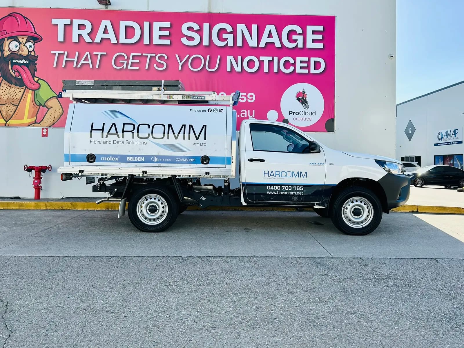 Harcomm Hilux canopy side profile, Tradie Signage banner