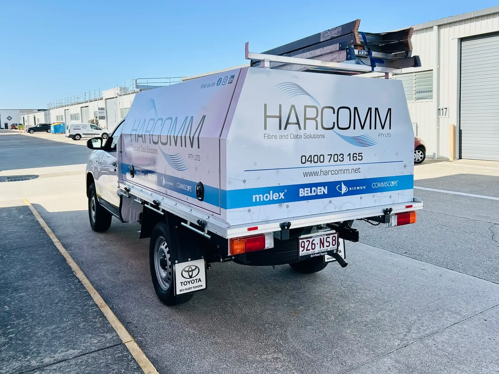 Harcomm Hilux canopy rear three-quarter, ladders on rack