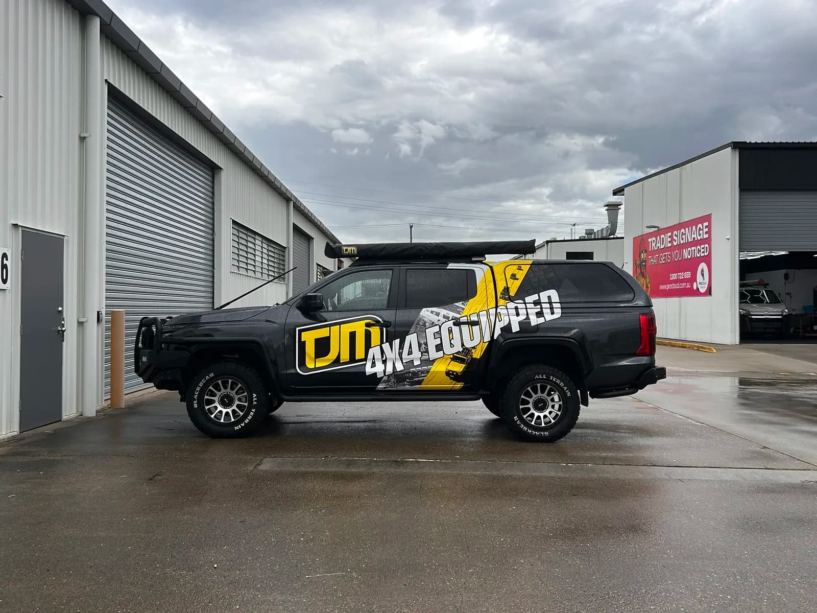 TJM Triton side profile, ProCloud signage behind