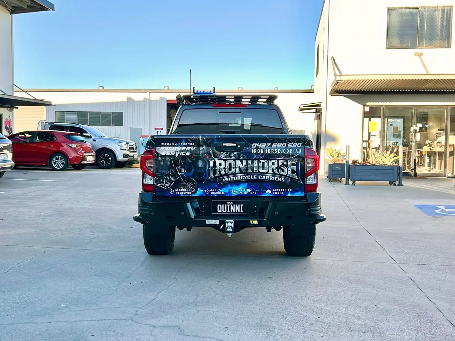 Ironhorse wrapped ute rear, dark graphics, outdoors