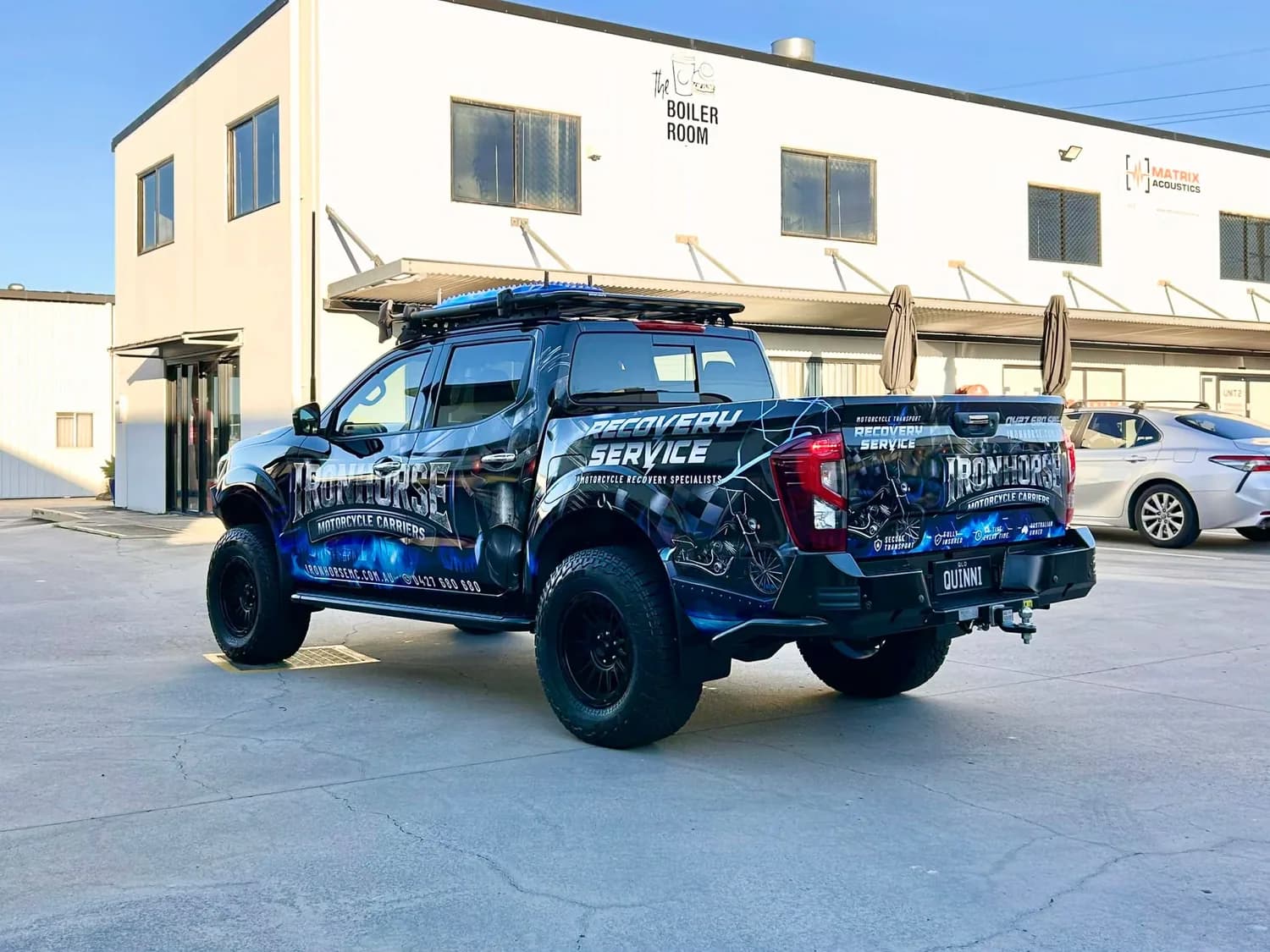Ironhorse blue 'Service' wrapped ute front three-quarter