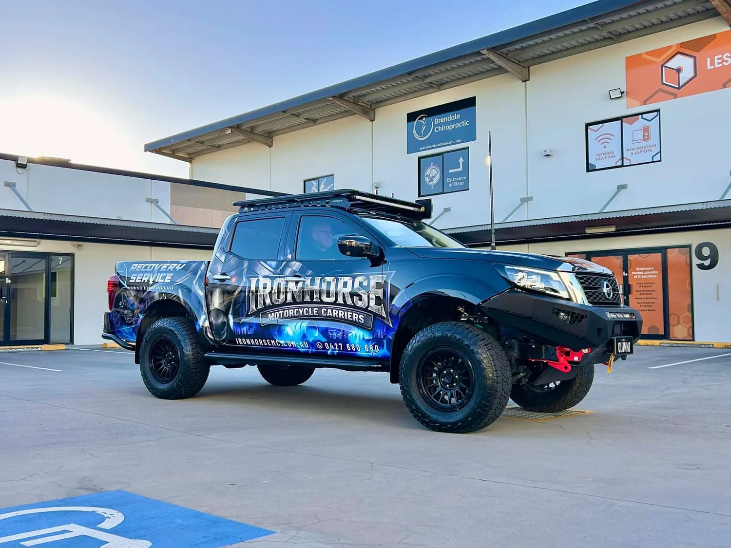 Ironhorse blue wrapped ute side profile outside building