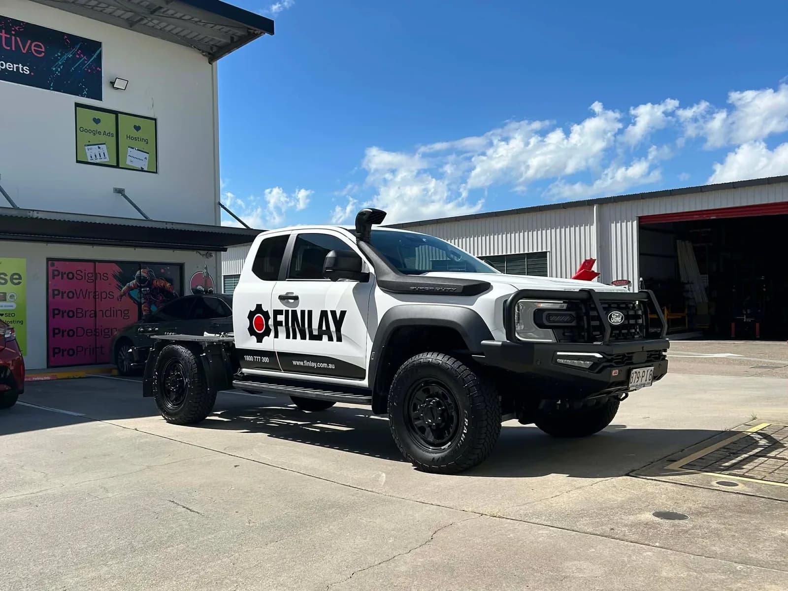Finlay Ford Ranger extra cab with black door graphics and bullbar, front three-quarter