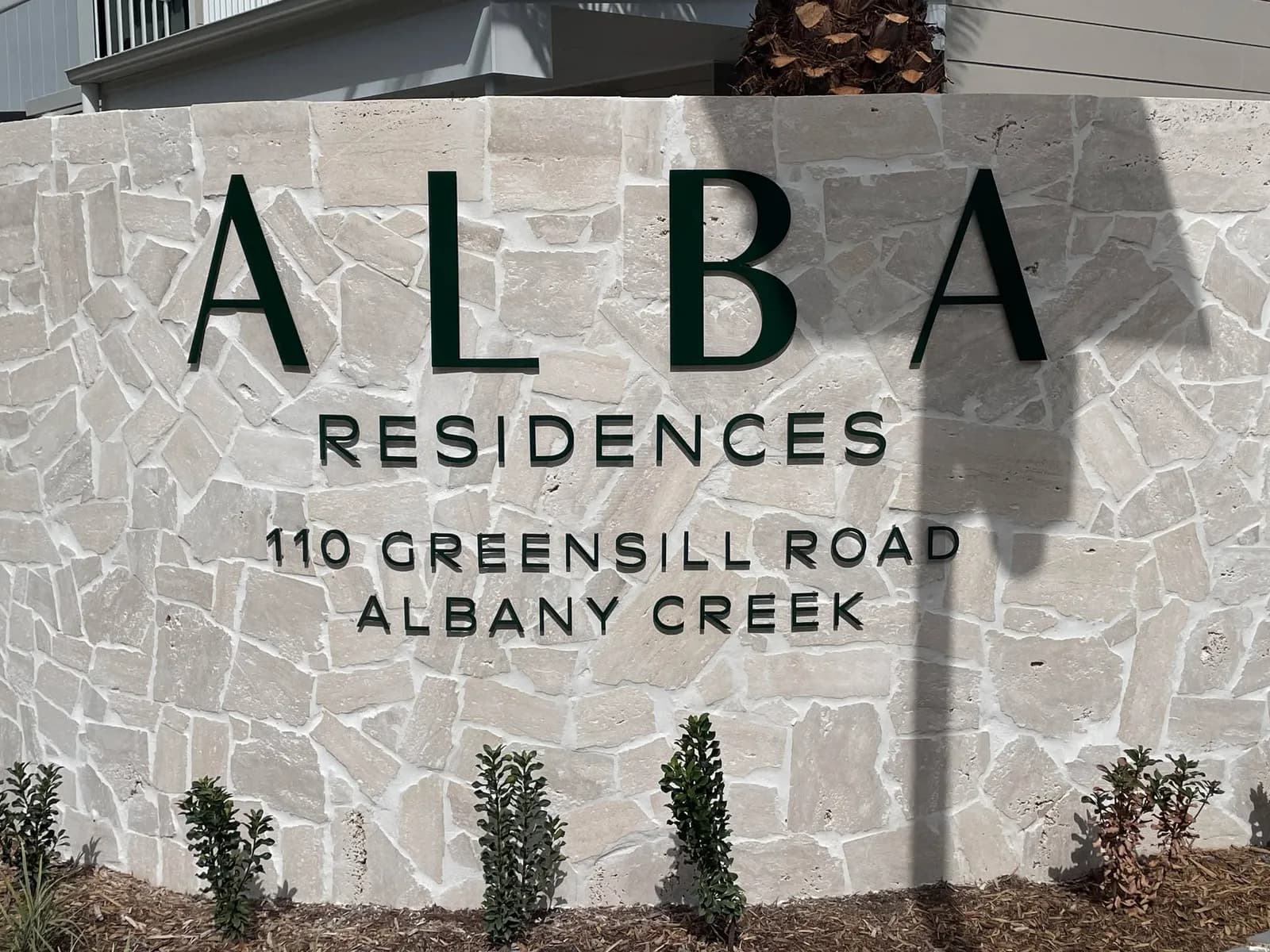 Alba Residences 3D letters on a sandstone entry wall