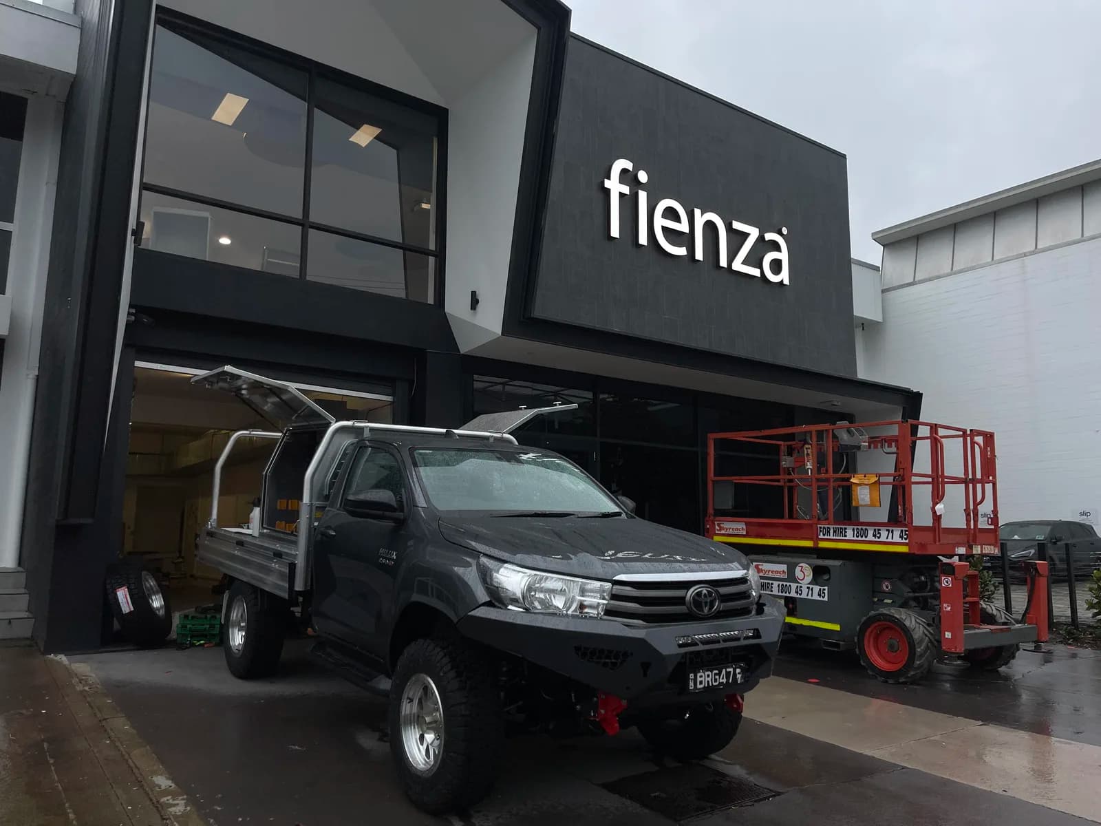 Fienza illuminated fascia sign, scissor lift on site during install