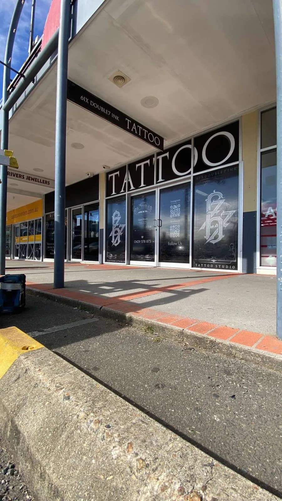 Tattoo studio shopfront with printed window graphics