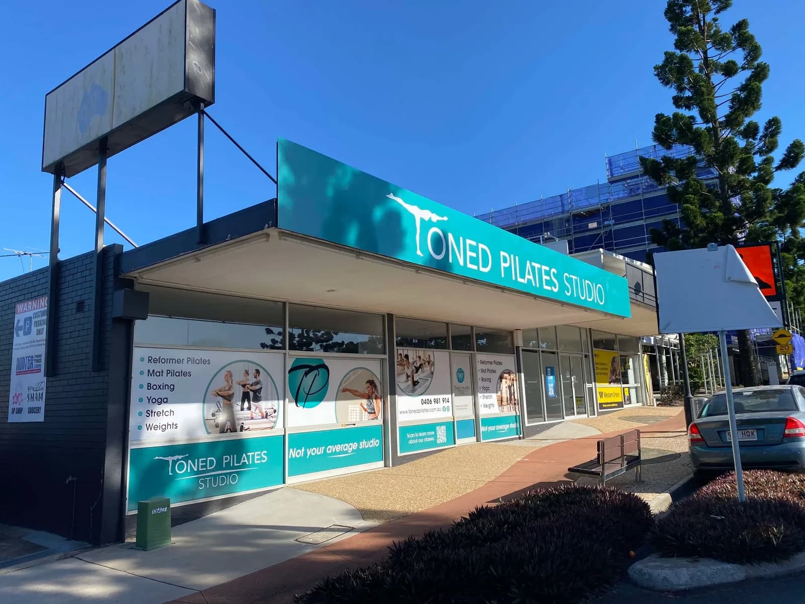 Toned Pilates Studio fascia sign and window graphics