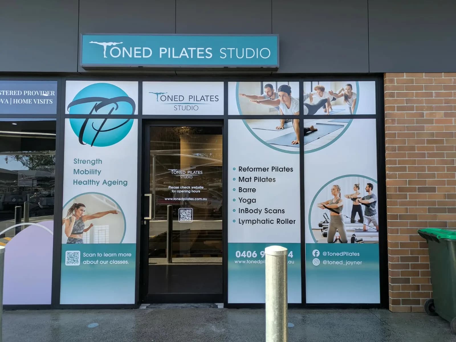 Toned Pilates Studio full window graphics and entry signage