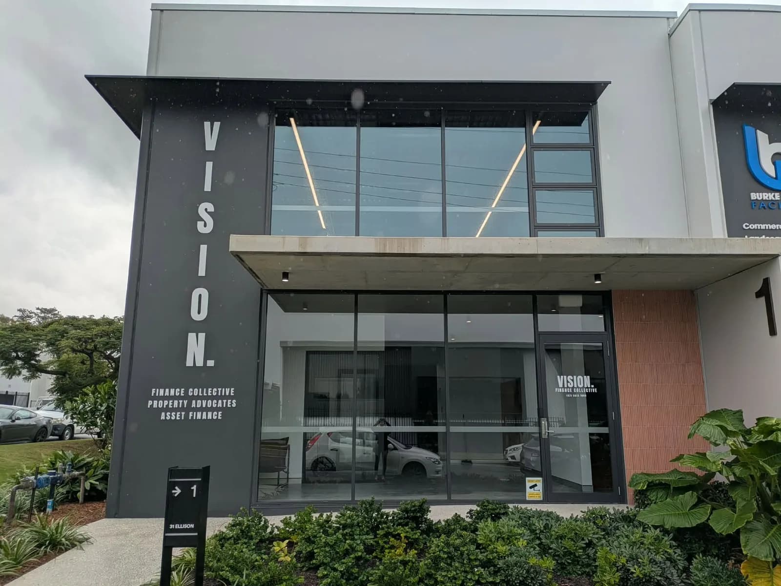 VISION. vertical 3D lettering on a dark building column