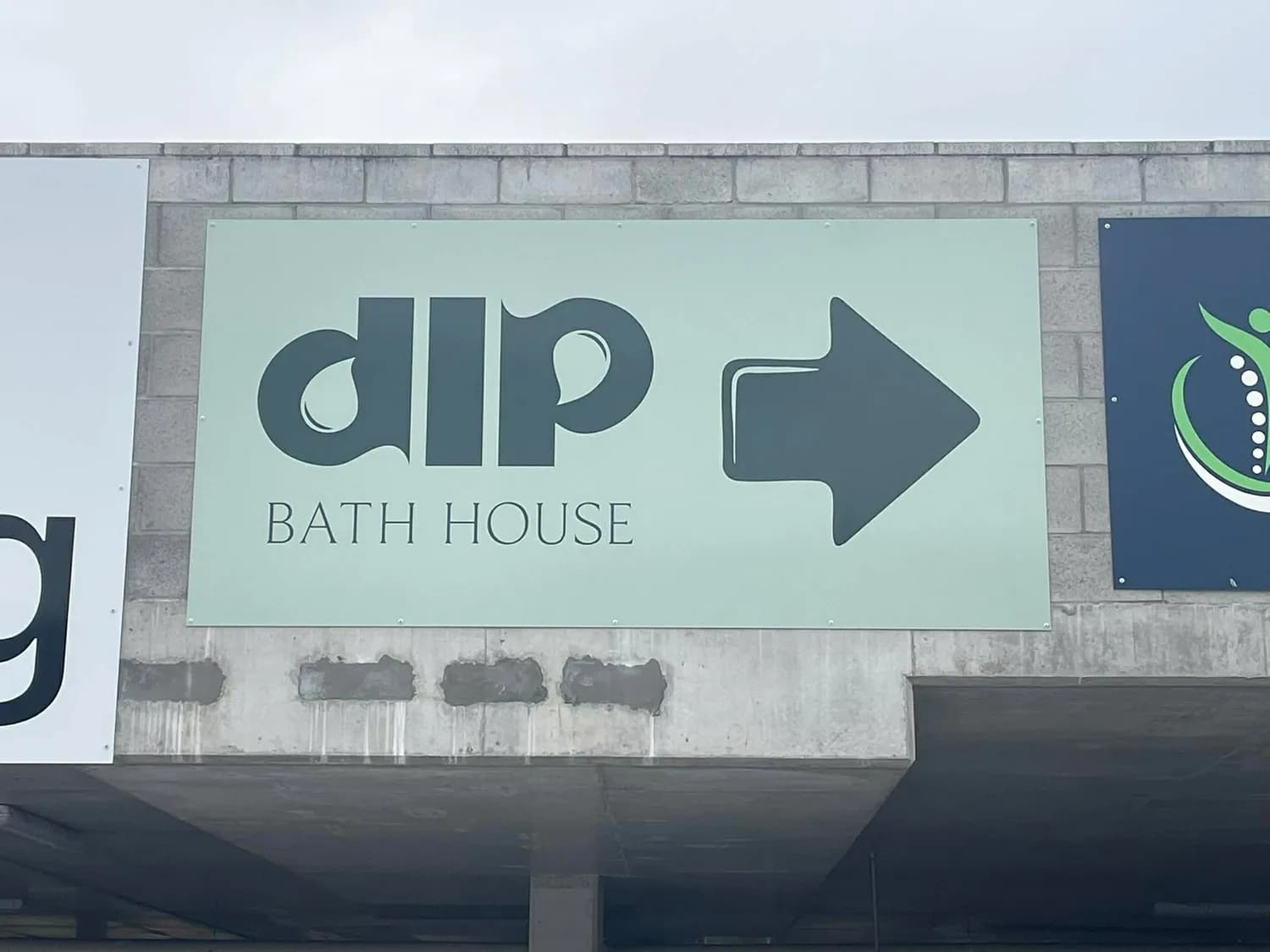 Freestanding dip Bath House directional pylon sign with arrow