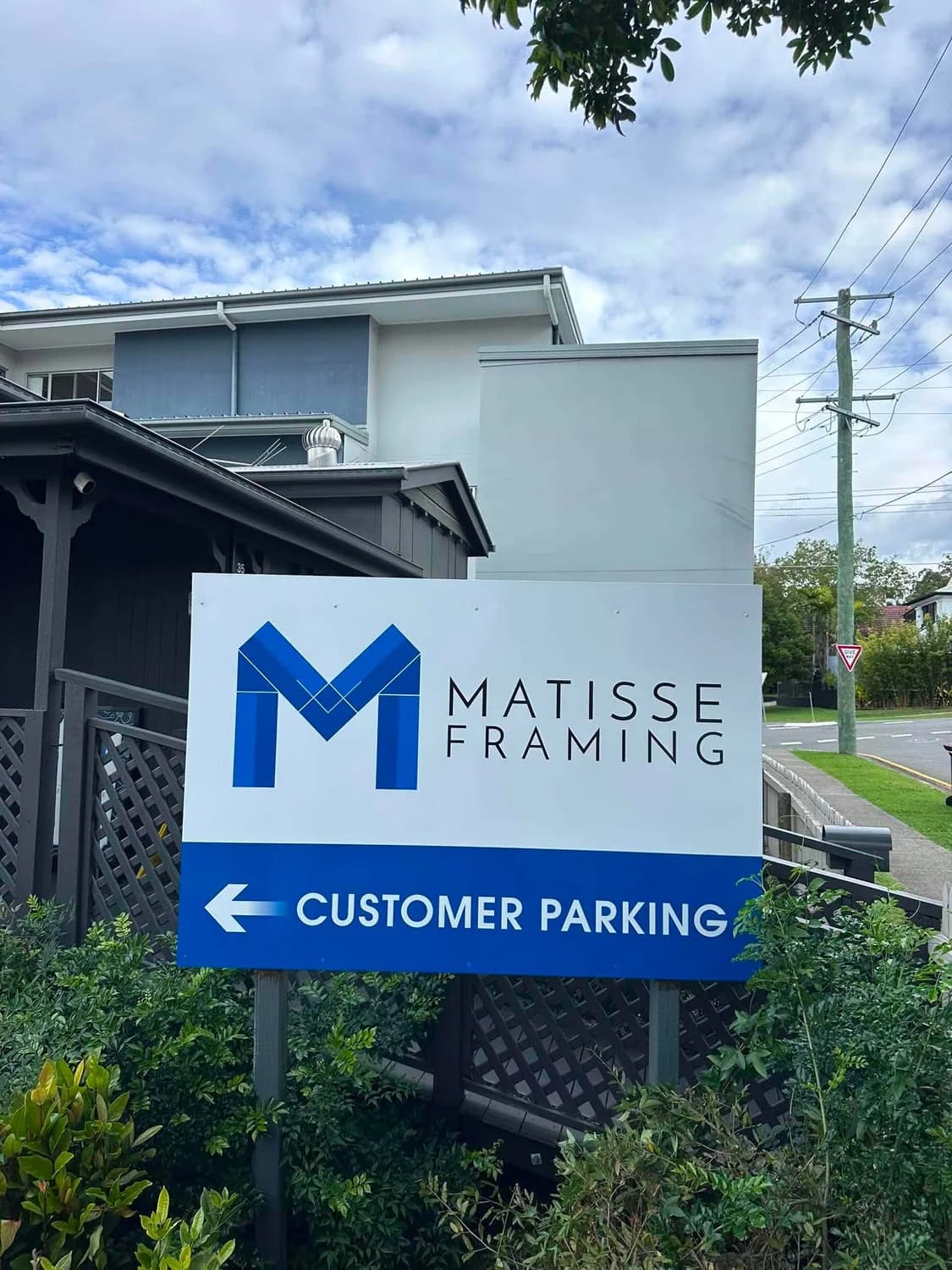 Matisse Framing freestanding pole sign with customer parking directional arrow