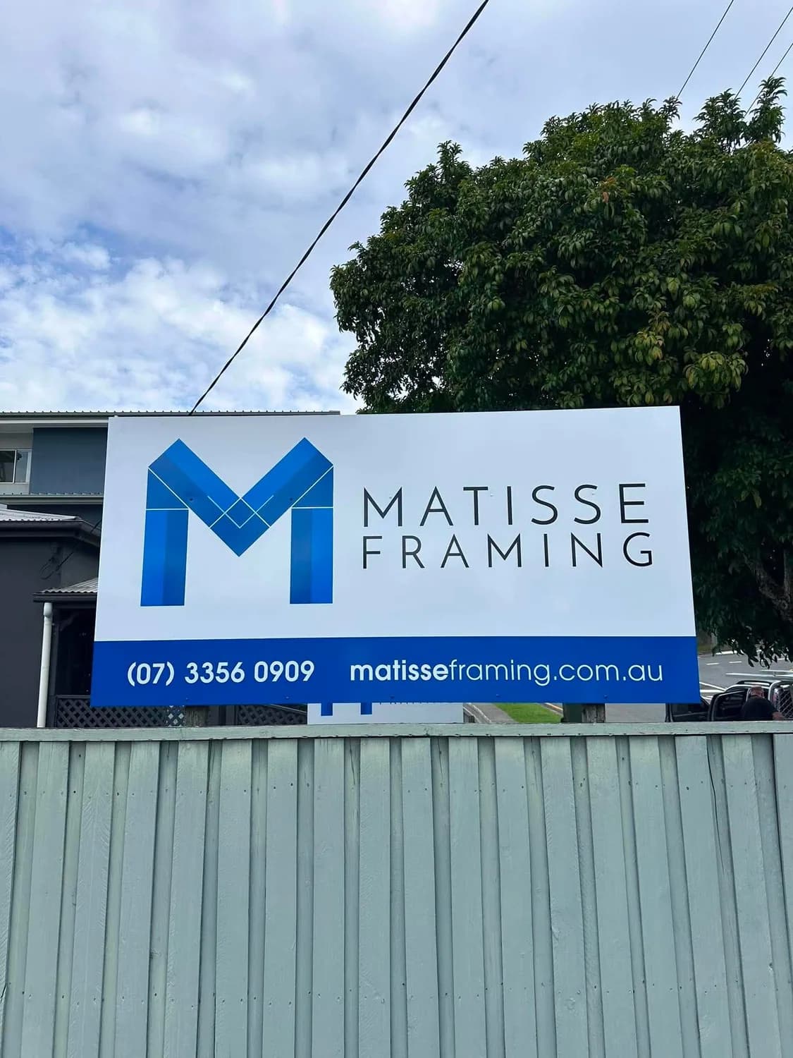 Matisse Framing freestanding fence-mounted sign with phone and website