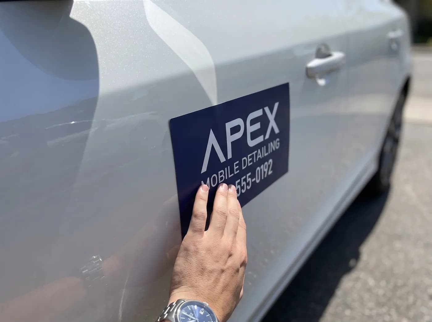 Placing a magnetic sign on a car door