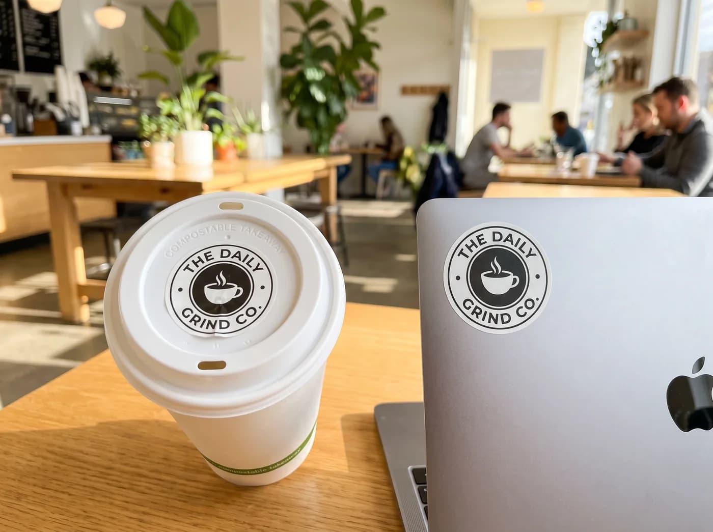 Logo stickers on a cup and laptop