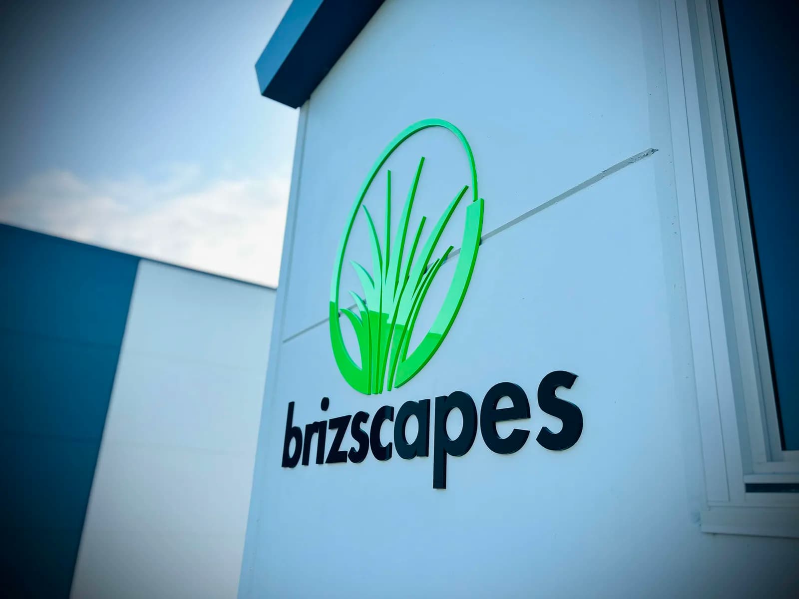 Brizscapes green 3D letters and leaf logo on a curved fascia