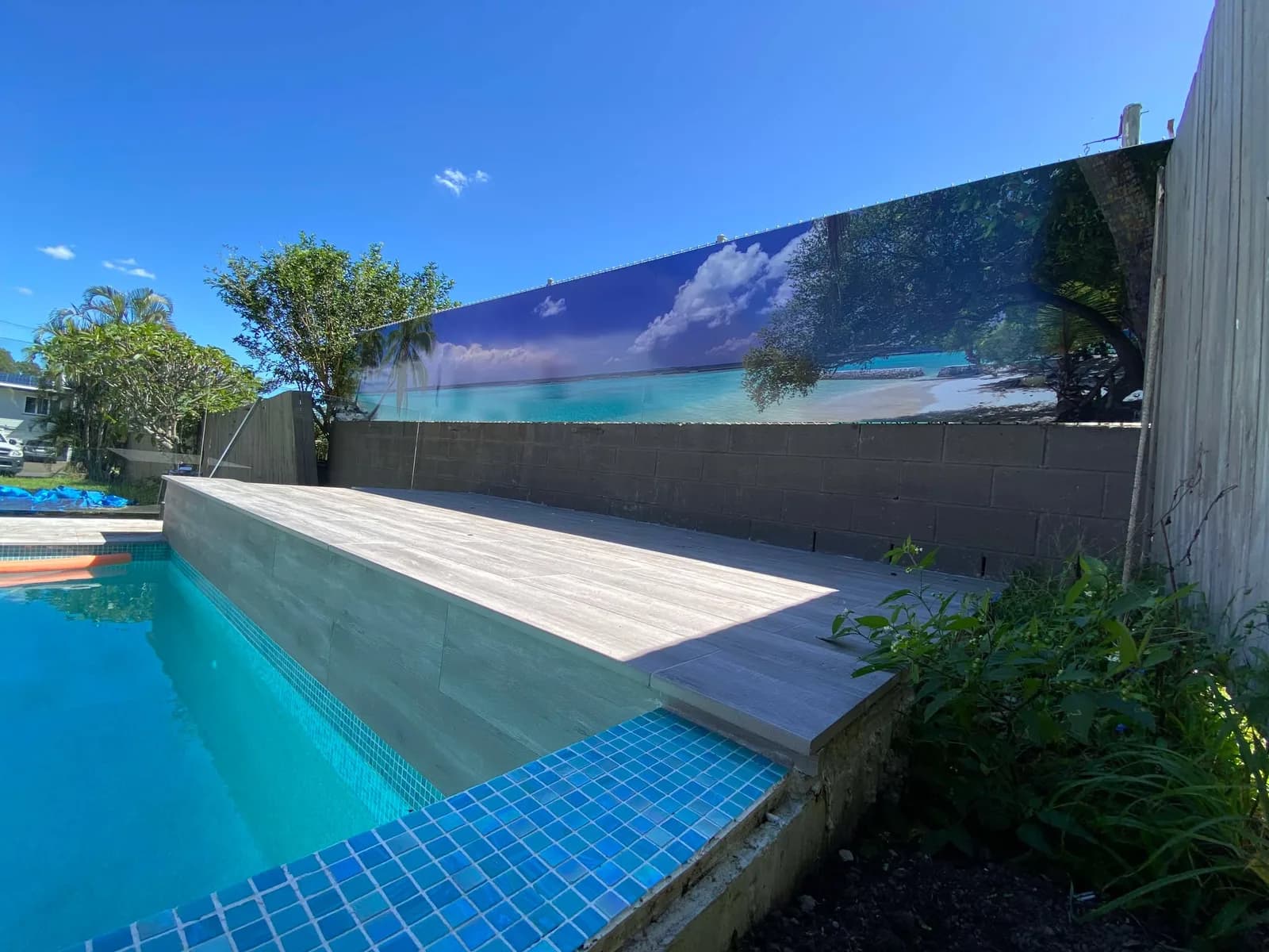 Ocean mural wall wrap above a pool