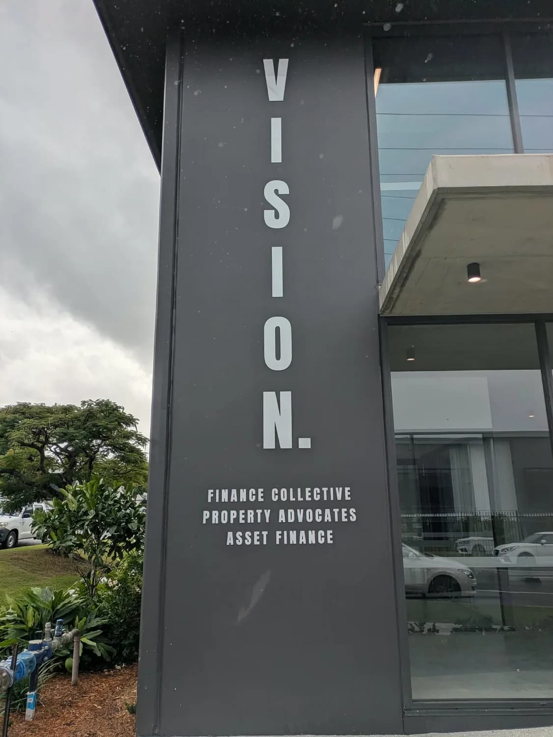 Vision Finance Collective black column exterior signage